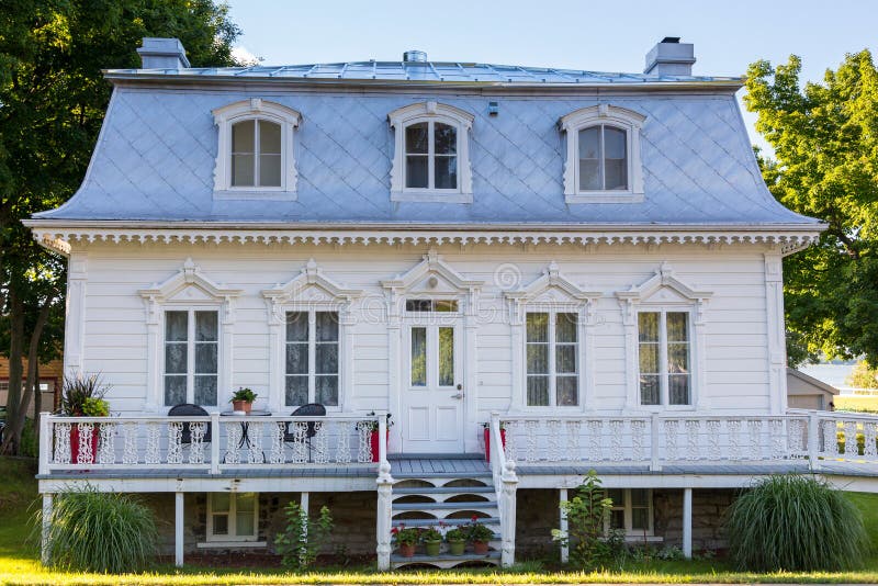 Regency-style white wooden country house with silver metal Mansard roof