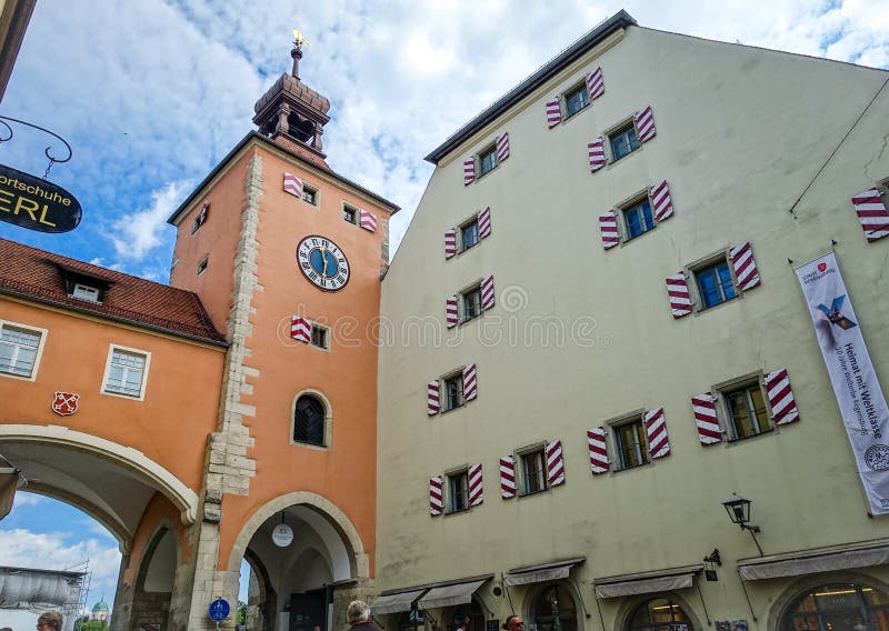 Regensburg, Germany - July, 09 2016: Clock Tower and Medieval Building in the City Entrance from the Stone Bridge stock images Regensburg, Germany - July, 09 2016: Clock Tower and Medieval Building in the City Entrance from the Stone Bridge stock images