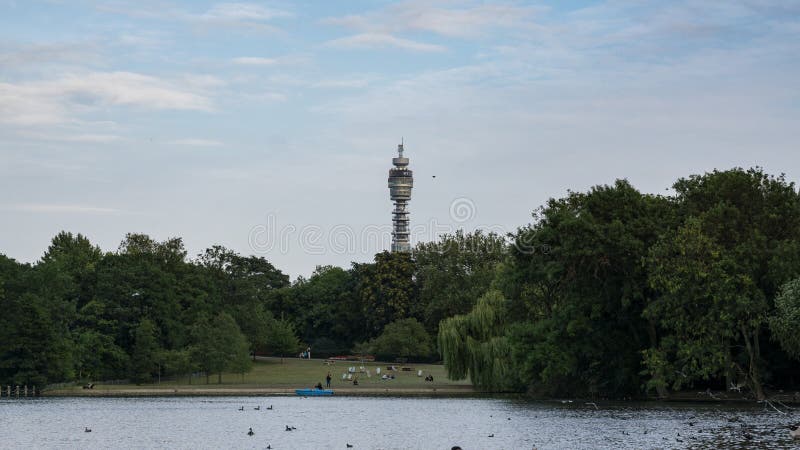 Regent`s Park in London, England with Lake in foreground, and the BT tower behind trees in the background.