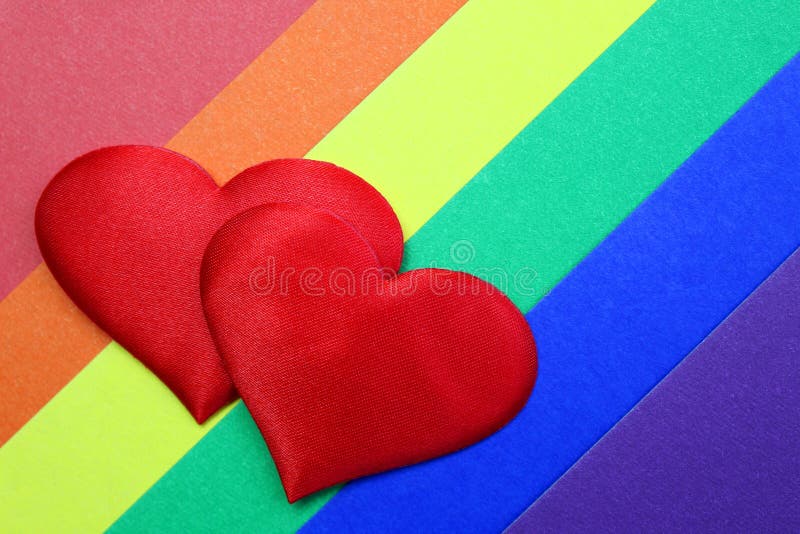 Regnbåge homosexuell bakgrund med röda hjärtan