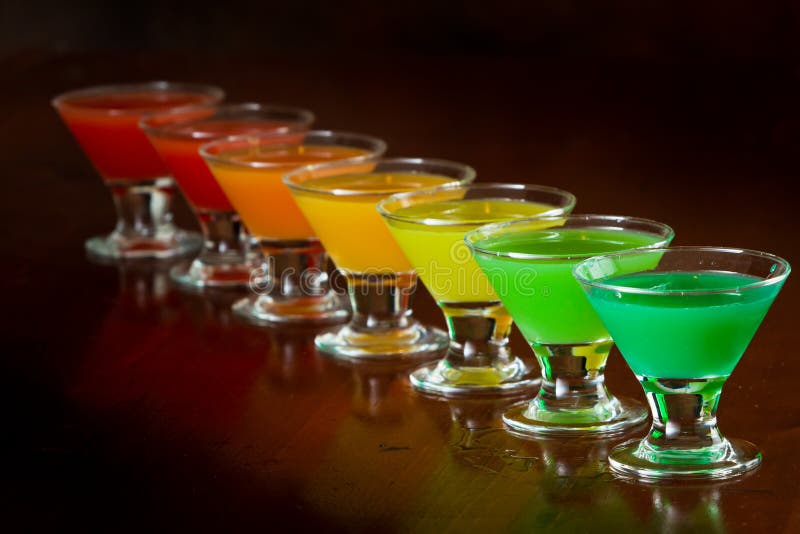 Classic bar flair trick, rainbow colored juice served in multiple shot glasses in a row. Classic bar flair trick, rainbow colored juice served in multiple shot glasses in a row