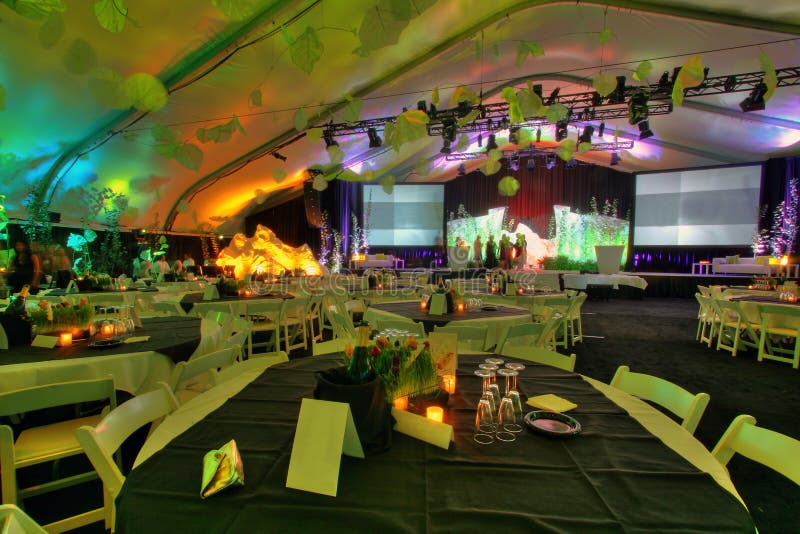 A large group party room table set inside a tent HDR. A large group party room table set inside a tent HDR