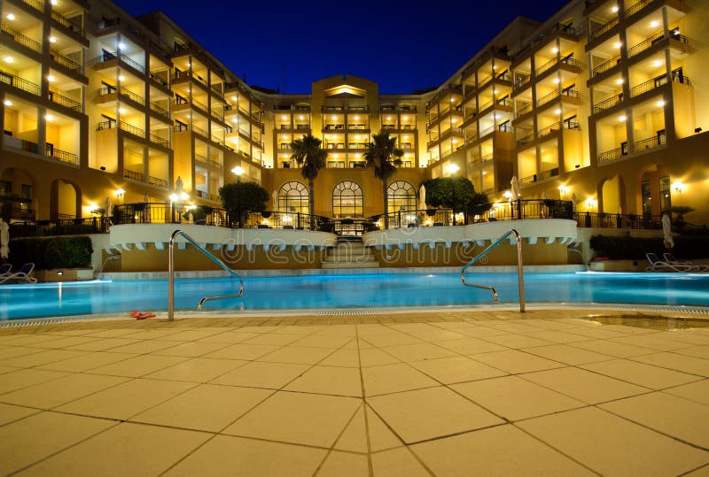 Luxury five star hotel pool at night; Relaxing vacation. Luxury five star hotel pool at night; Relaxing vacation