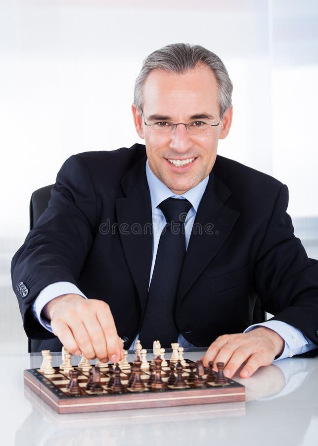 Reifer Geschäftsmann, der Schach spielt lizenzfreie stockbilder Reifer Geschäftsmann, der Schach spielt lizenzfreie stockbilder