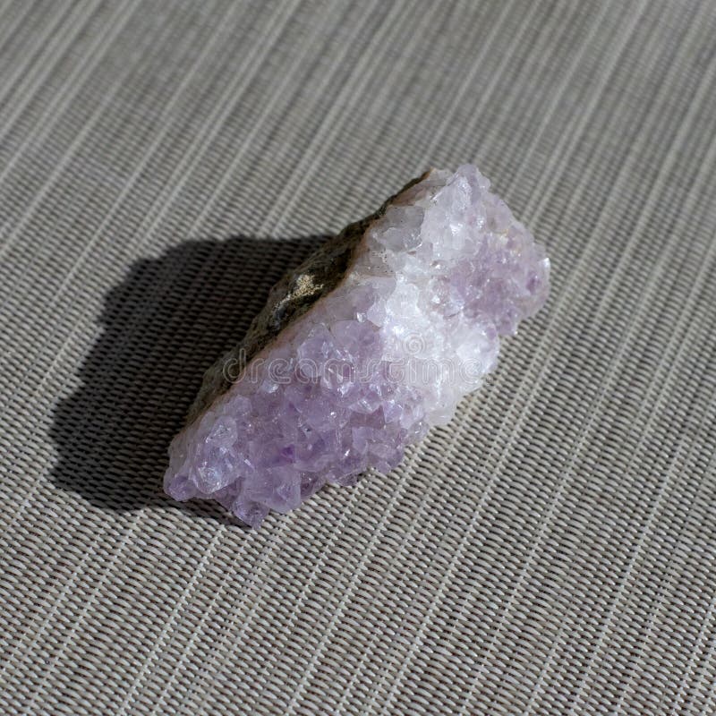 set of various amethyst natural mineral stones and gemstones on grey paper background top view. set of various amethyst natural mineral stones and gemstones on grey paper background top view