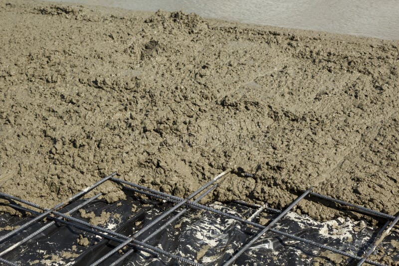 Reinforcement Steel Mesh Partly Covered with Fresh Rough Concrete Stock