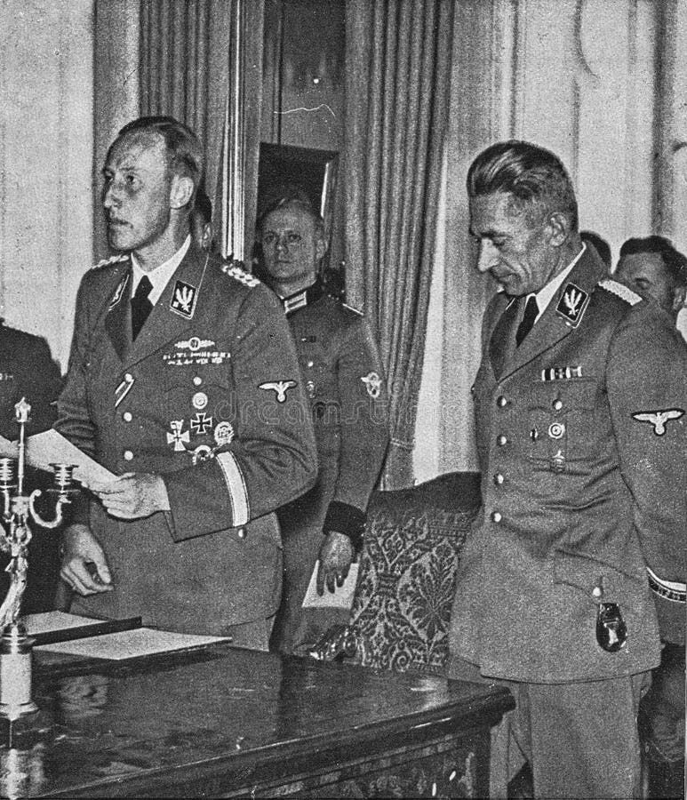 PRAGUE, PROTECTORATE OF BOHEMIA AND MORAVIA - CIRCA 1942: Reinhard Heydrich-left with Karl Hermann Frank. Heydrich gives a speech to audience. PRAGUE, PROTECTORATE OF BOHEMIA AND MORAVIA - CIRCA 1942: Reinhard Heydrich-left with Karl Hermann Frank. Heydrich gives a speech to audience