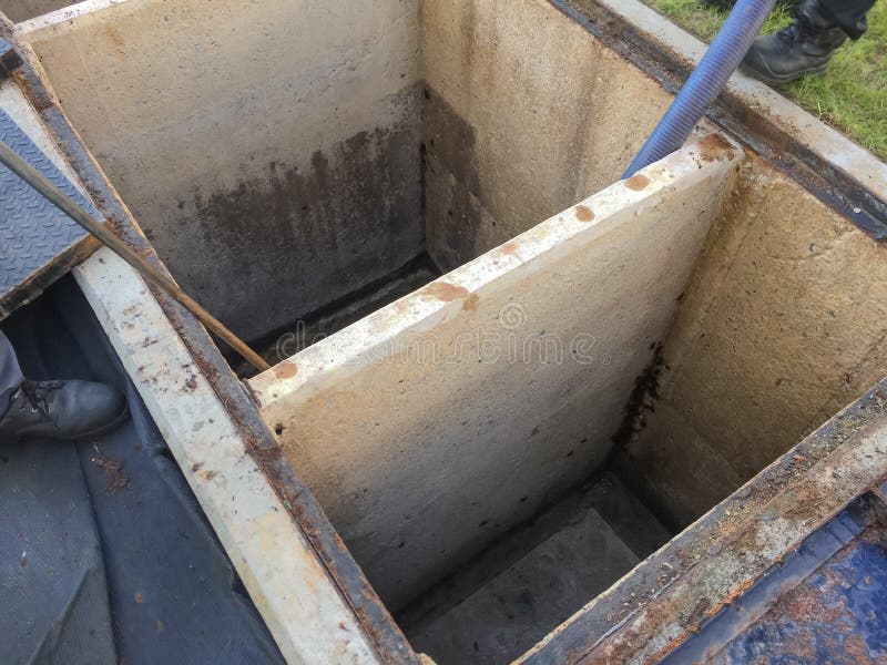 Cleaning grease trap tank to sewage tank at factory. Cleaning grease trap tank to sewage tank at factory