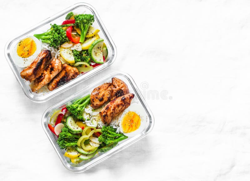 Rice, stewed vegetables, egg, teriyaki chicken - healthy balanced lunch box on a light background, top view. Home food for office concept. Copy space. Rice, stewed vegetables, egg, teriyaki chicken - healthy balanced lunch box on a light background, top view. Home food for office concept. Copy space