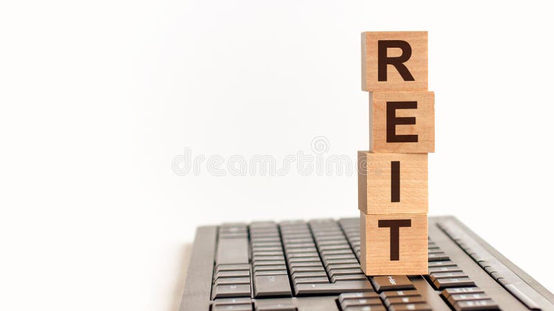 Reit in 3d wooden alphabet letters on a keyboard background with copy space, concept stock images