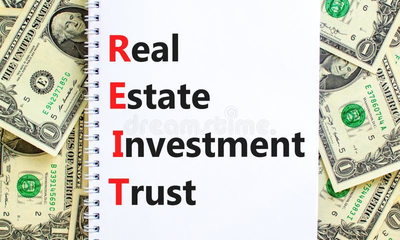 REIT real estate investment trust symbol. Concept words REIT real estate investment trust on note on beautiful white background. stock photo