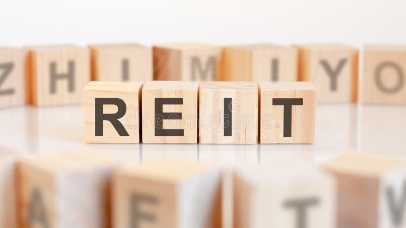 Reit - wooden letters on the office desk, white background, business concept stock photos