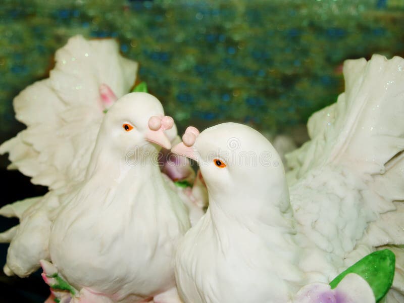 A beautiful crafted couple of porcelain dove birds, kissing each other. A beautiful crafted couple of porcelain dove birds, kissing each other.