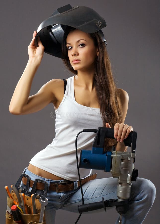 Reizvoller Bauarbeiter der jungen Frau lizenzfreies stockbild Reizvoller Bauarbeiter der jungen Frau lizenzfreies stockbild