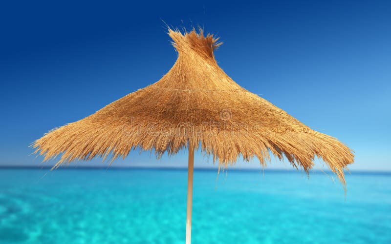 Relaxing on Tropical Beach under umbrella on sunny day. Relaxing on Tropical Beach under umbrella on sunny day