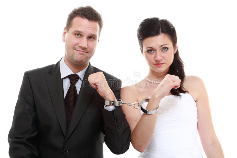 Break up ending relationship between husband and wife. Couple in divorce crisis. Man women unhappy holding hands in handcuffs. Isolated. Break up ending relationship between husband and wife. Couple in divorce crisis. Man women unhappy holding hands in handcuffs. Isolated