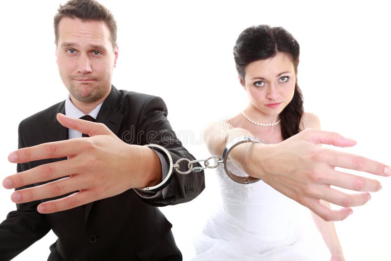 Break up ending relationship between husband and wife. Couple in divorce crisis. Man women unhappy holding hands in handcuffs. Isolated. Break up ending relationship between husband and wife. Couple in divorce crisis. Man women unhappy holding hands in handcuffs. Isolated