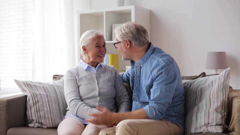 Happy senior couple hugging at home