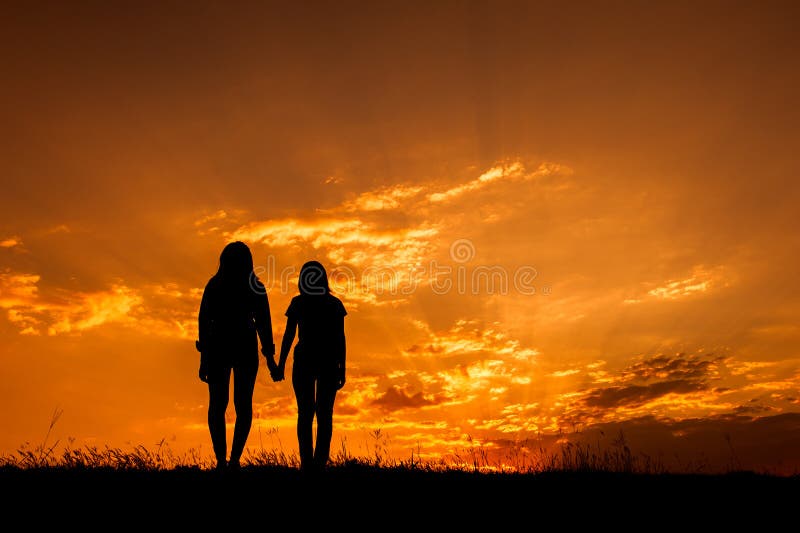 Relax women standing and sunset silhouette stock photography