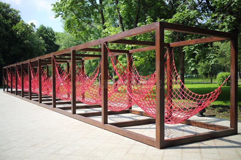 Relaxation area with red hammocks in the city stock photography
