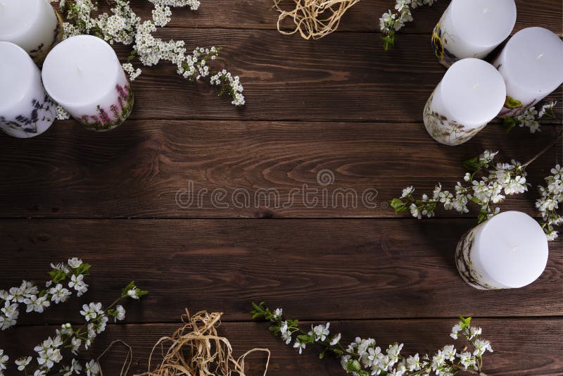 Relaxation and spa floral concept with candles on wooden background