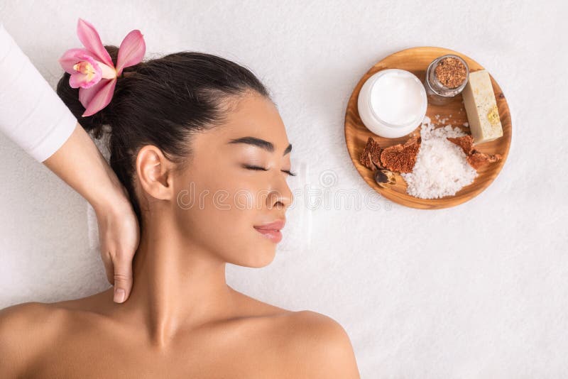 Relaxed Asian Woman Enjoying Neck Massage With Natural Ingredients