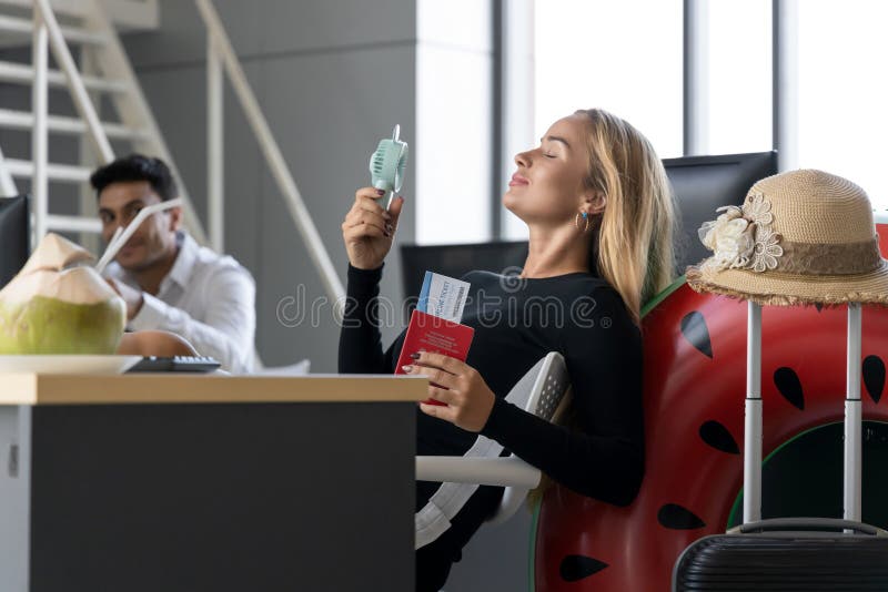 Relaxed business woman holding passport in workplace of office. Summer vacations concept royalty free stock photography Relaxed business woman holding passport in workplace of office. Summer vacations concept royalty free stock photography