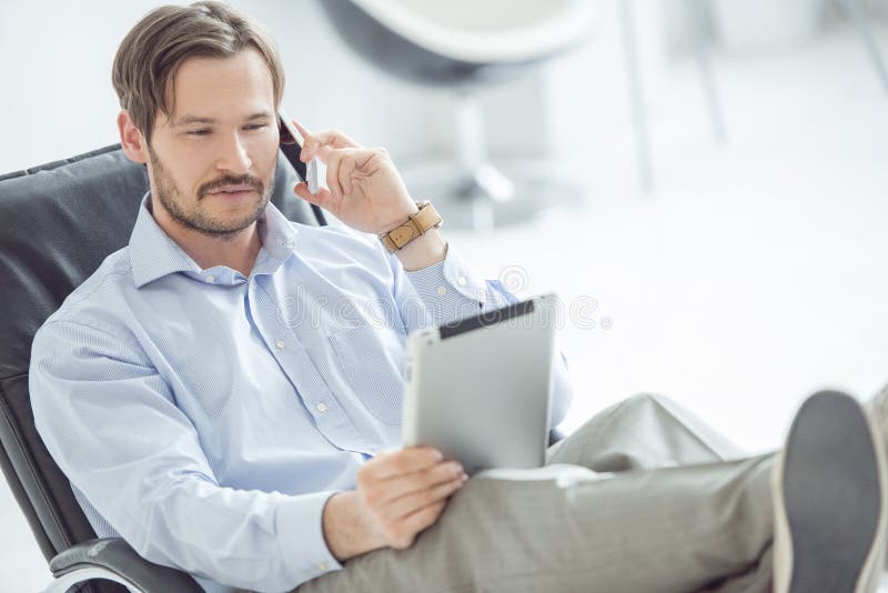 Relaxed businessman talking mobile phone royalty free stock photos