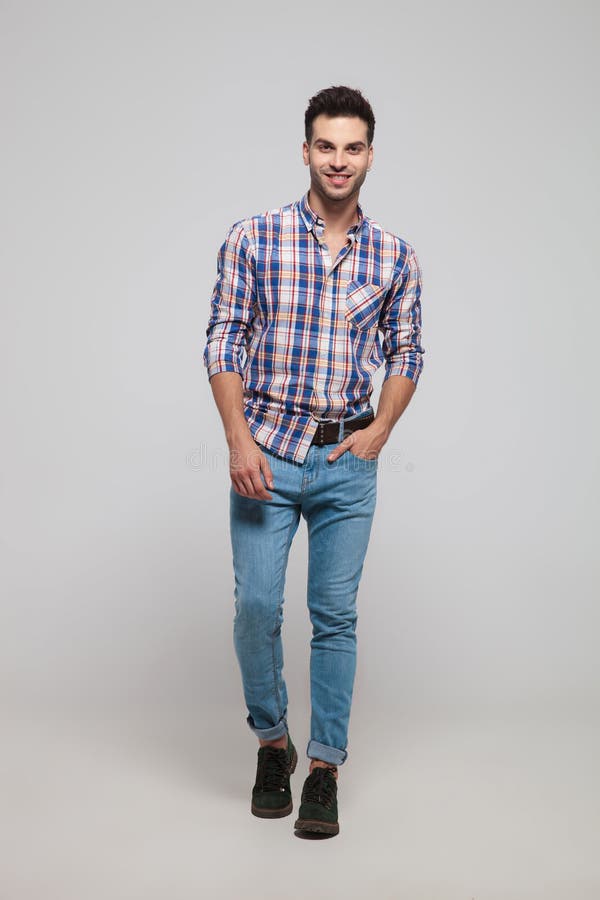 Relaxed casual man wearing shirt with checkers stepping forward