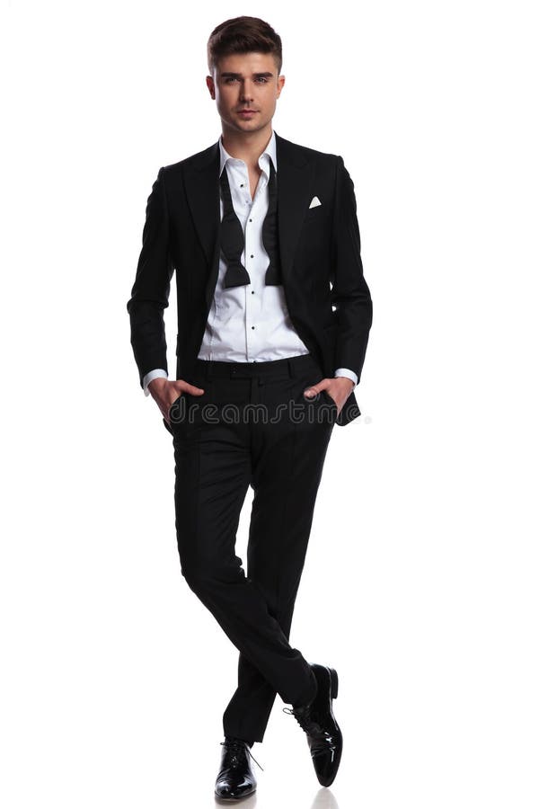 Relaxed Elegant Man with Undone Bowtie Standing Cross-legged Stock ...