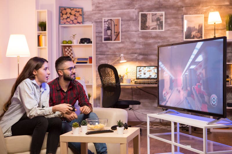 Relaxed Girlfriend Playing Video Games on Television Stock Image
