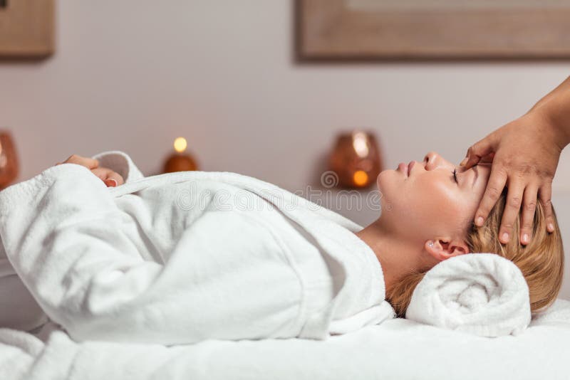 Relaxed Gorgeous Lying In Bathrobe And Getting A Facial Massage Stock 