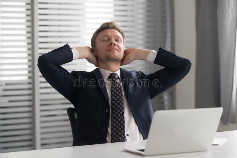 Relaxed positive mindful male manager having rest at office. royalty free stock photos Relaxed positive mindful male manager having rest at office. royalty free stock photos