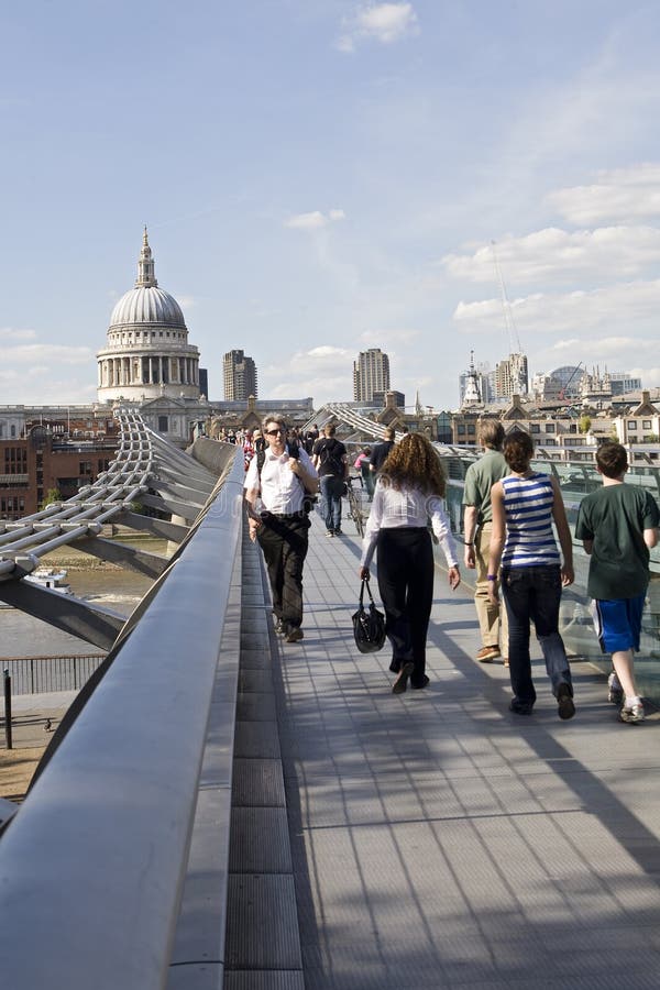 Relaxed tourists crossing millenium bridge