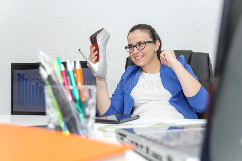 Relaxed and winning business woman sitting with her legs on desk royalty free stock photos Relaxed and winning business woman sitting with her legs on desk royalty free stock photos