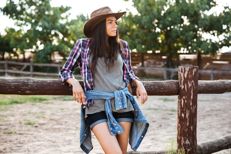 Relaxed Woman Cowgirl In Hat Standing And Resting On Ranch Stock Image