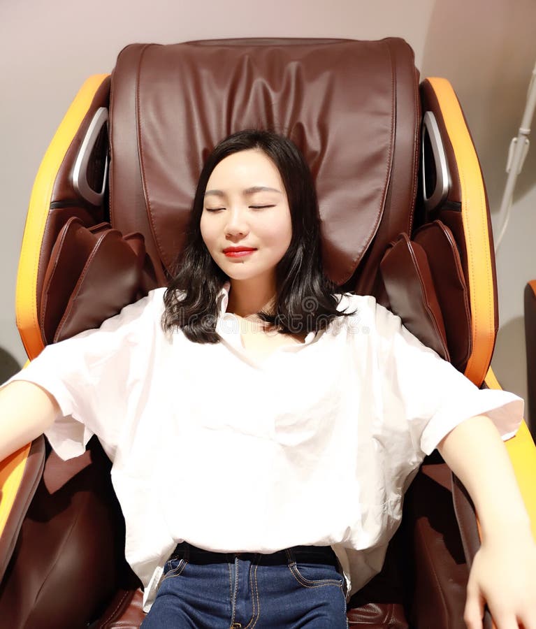 Relaxed Woman Girl Lying On Electric Automatic Massage Chair