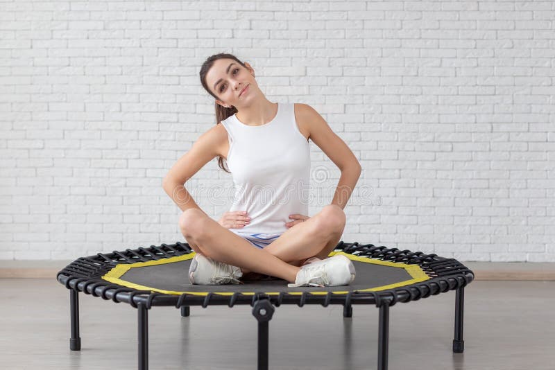 Relaxed woman jumping on trampoline. 