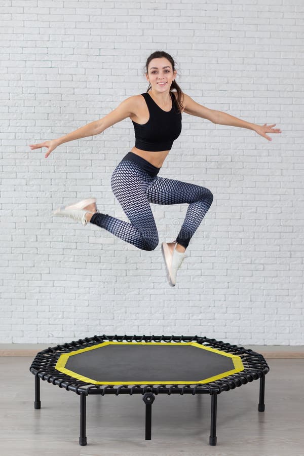 Relaxed woman jumping on trampoline. 