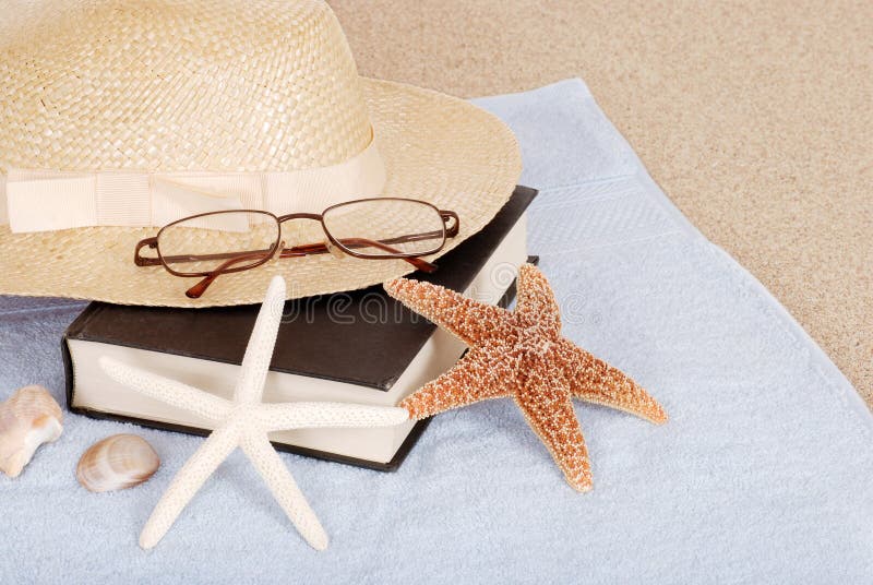 Relaxing beach concept book hat glasses