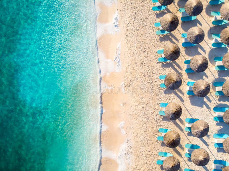 Relaxing beach top down view with chairs and umbrellas