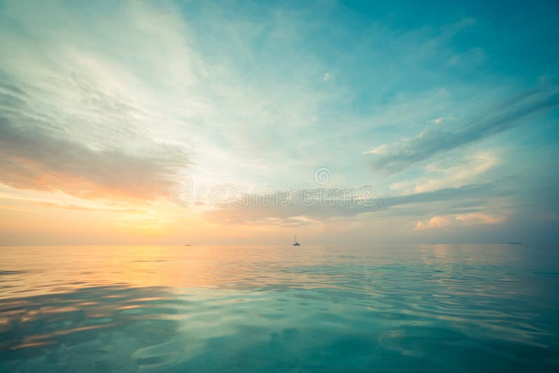 Relaxing and calm sea view. Open ocean water and sunset sky. Tranquil nature background. Infinity sea horizon