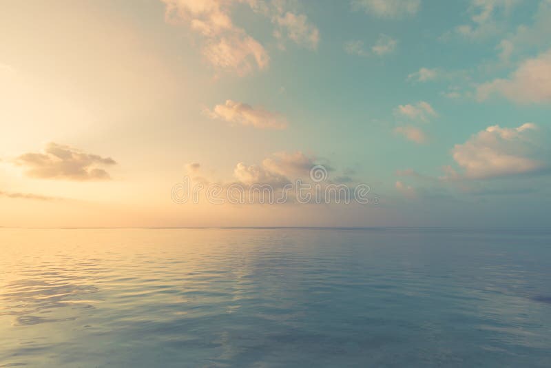 Relaxing and calm sea view. Open ocean water and sunset sky. Tranquil nature background. Infinity sea horizon