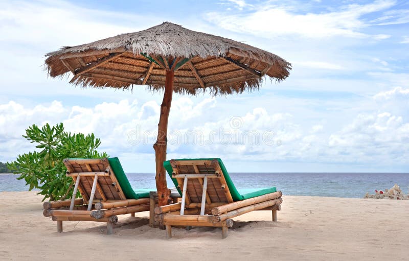 Relaxing couch chairs on white sandy Beach