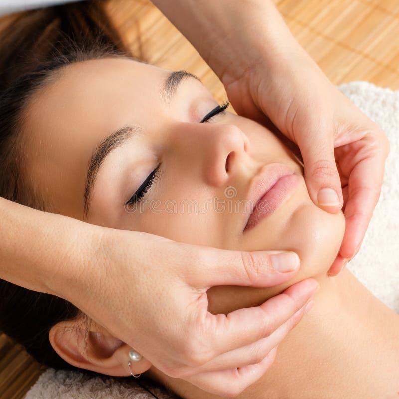 Close up portrait of Relaxing facial massage on female chin.