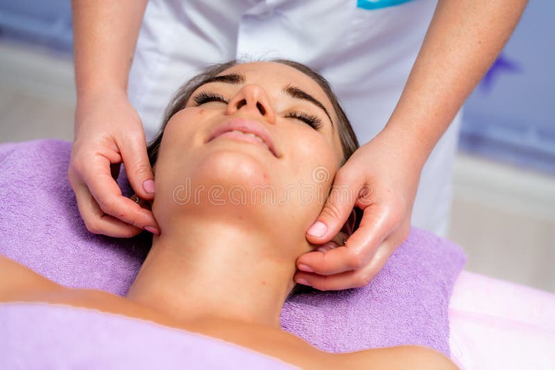 Relaxing Massage European Woman Getting Facial Massage In Spa Salon Side View Stock Image