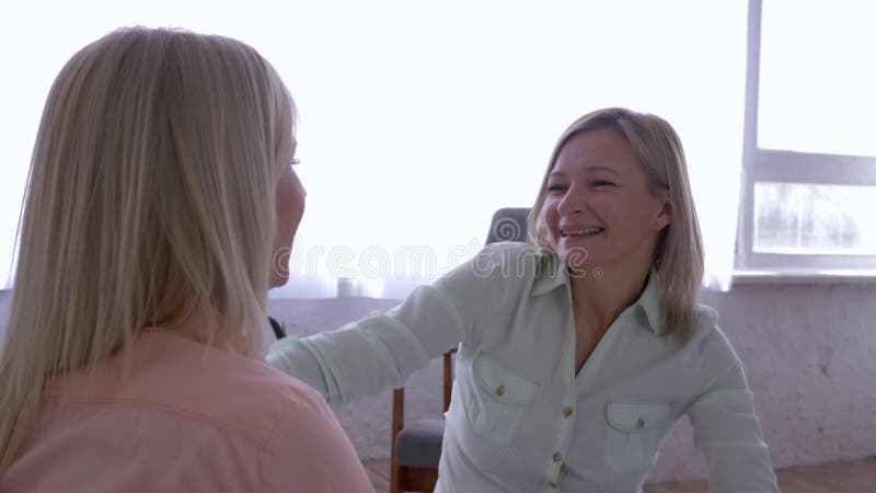 Relazione delle figlie della madre, donna allegra divertendosi e ridendo mentre comunicando con la ragazza che abbraccia sul lett stock footage