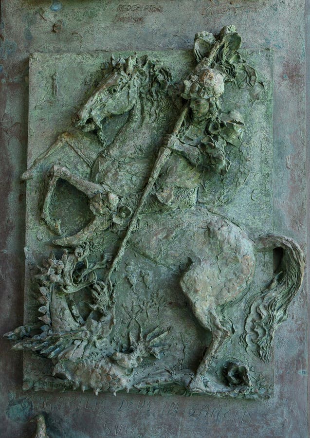 Pictured is a bronze door panel of the Church of San Giorgio atop a hill in Portofino, Italy.  It represents the legend of Saint George taming and slaying a dragon that demanded human sacrifices.  The saint thereby rescues the princess chosen as the next offering. Pictured is a bronze door panel of the Church of San Giorgio atop a hill in Portofino, Italy.  It represents the legend of Saint George taming and slaying a dragon that demanded human sacrifices.  The saint thereby rescues the princess chosen as the next offering.