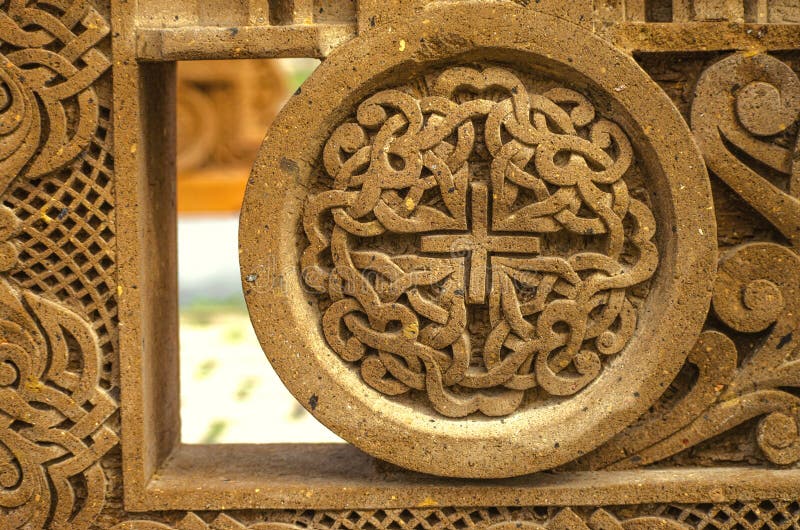 Relief ornament on a red volcanic stone, carved from intersecting strips with a small cross in the middle, framed by a round carve