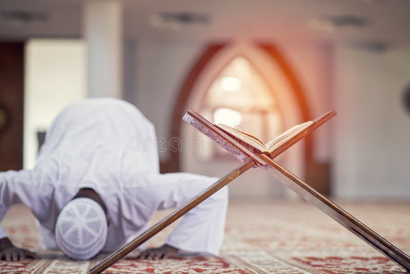 Religious black muslim man praying inside the mosque royalty free stock photo